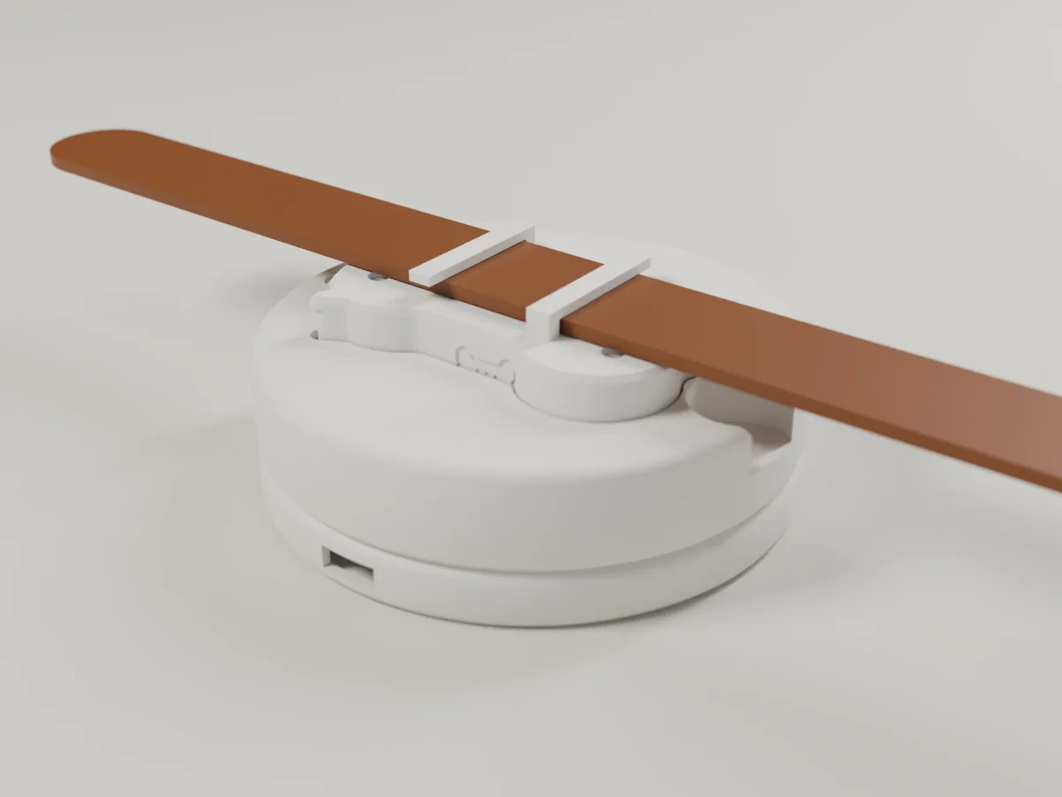Render of the Lite base: a round white dock with a collar laid across it and the tag seated on top.
